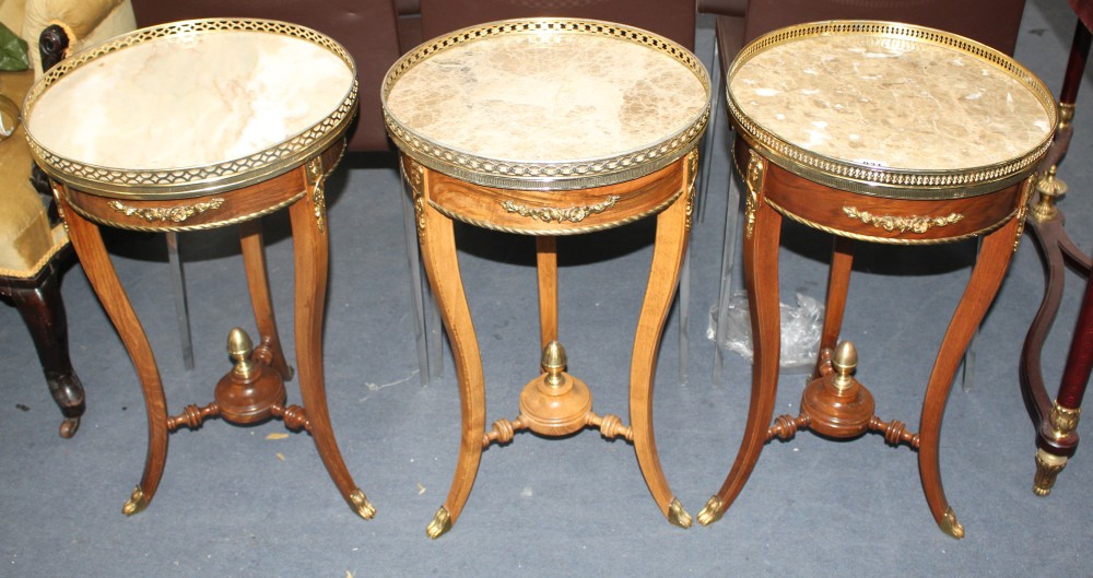 A near set of three Meuble Francais marble topped occasional tables, Diam.40cm H.67cm